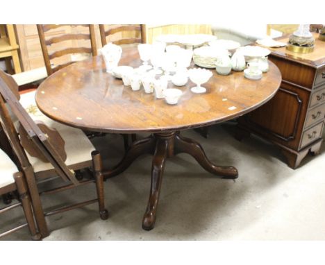 A good quality oak extending dining table with two extra leaves and a set of sic ladder back chairs 