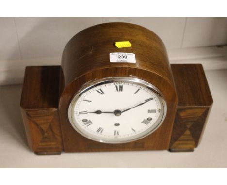 An Art Deco mahogany and walnut cased three hole mantel clock 