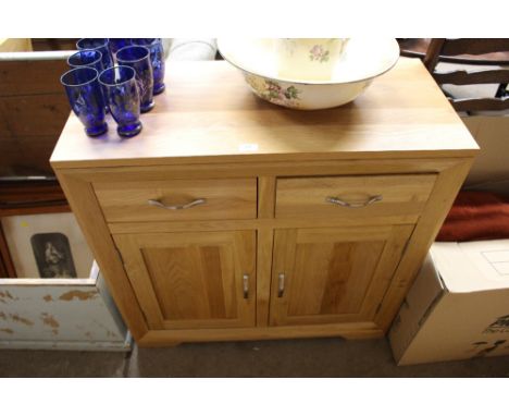 A light oak two drawer side board 