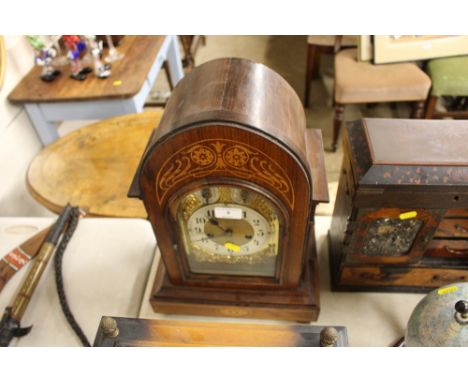 An Edwardian rosewood and inlaid three hole chiming mantel clock 