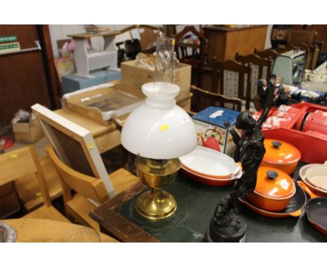 A brass oil lamp with milk glass shade 