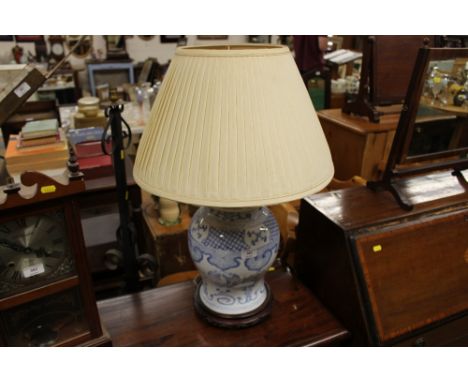 A Chinese blue and white baluster table lamp and shade