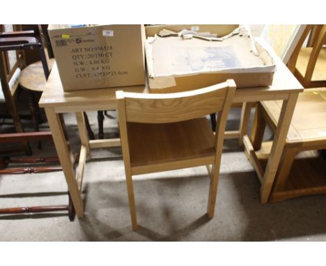 A light oak table and chair 