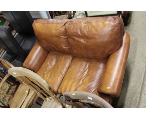 A brown leather two seater sofa