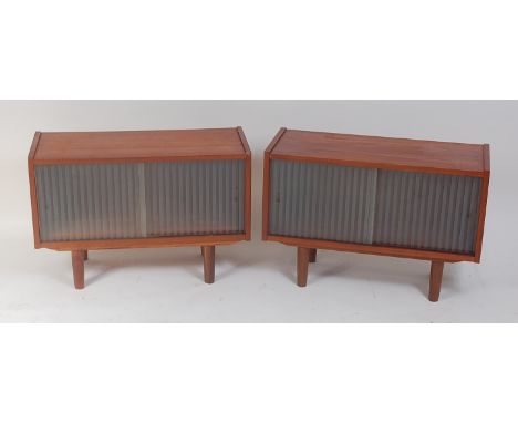 A pair of 1960s Danish teak low side cabinets, each having twin frosted glazed 'sundial' sliding doors, on turned supports, h