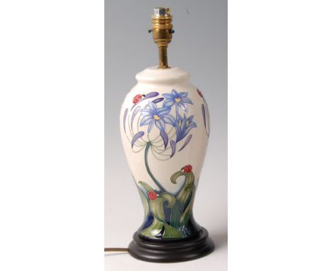 A modern Moorcroft pottery table lamp in the Ladybird pattern, of baluster form, underglaze painted and tube-lined decorated,