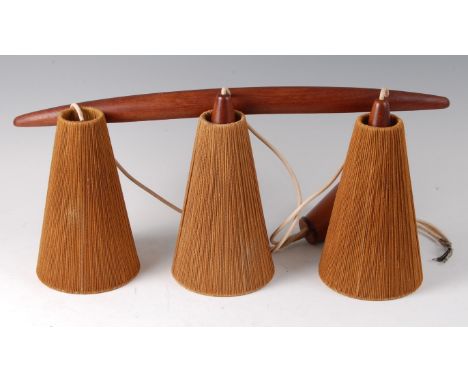 A 1960s Danish teak framed triple hanging ceiling light, having curved fitting over conical rattan lightshades, w.62.5cm