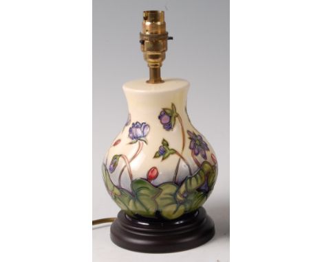 A modern Moorcroft pottery lamp in the Ashwood Hepatica pattern, by Emma Bossons, of lower bulbous form, underglaze painted a