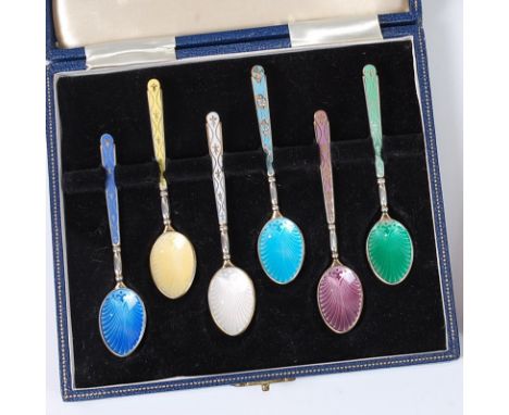 A cased set of six silver and guilloche enamel decorated teaspoons, each decorated in various colours and housed in fitted Ga