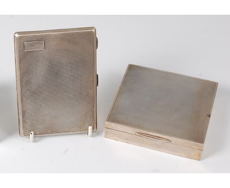 A 1960s silver table cigarette box, of square form, the hinged cover with engine turned decoration, wood-lined interior, make