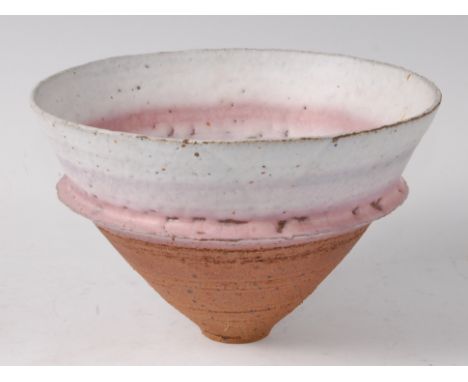 Robin Welch (b.1936) - A stoneware footed bowl, partially glazed in tones of white and pink, with proud concentric banding to