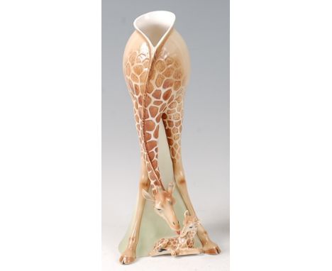 A Franz giraffe ceramic vase, of baluster form, modelled with a recumbent baby giraffe at base, printed backstamps verso, h.3