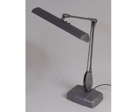 A 1960s Dazor Floating Fixture industrial anodised metal desk lamp, having rotating and hinged action, raised on heavy integr