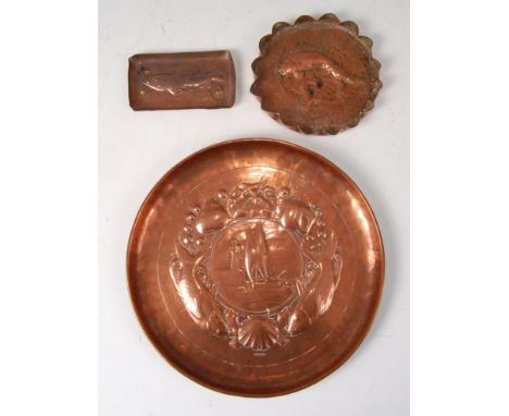 An early 20th century Newlyn School circular embossed copper dish, decorated with lighthouse and sailing boat within a harbou