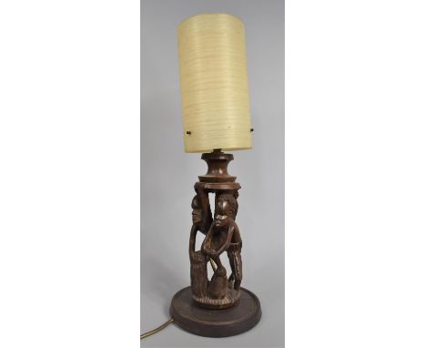 A Carved African Souvenir Figural Table Lamp with Shade, 54cms High 