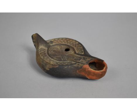 A Terracotta Oil Lamp with Incised Decoration, Some Chips, 13cms Long 