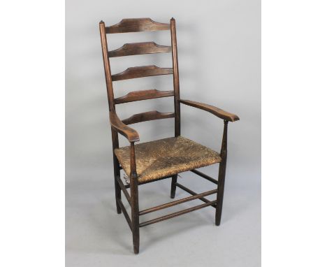 An Oak Framed Ladder Back Rush Seated Armchair 