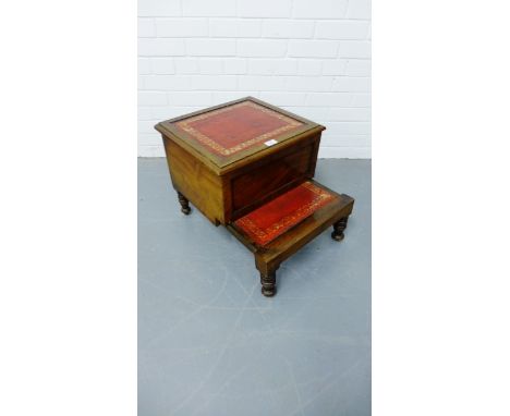 A Victorian mahogany bed step commode having a moulded top with red skiver insert enclosing commode above pull out step raise