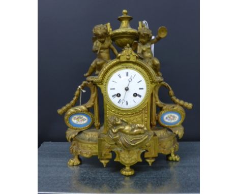 Gilt metal Louis XV style mantle clock, the enamel dial with Roman numerals, flanked by putti and Sevres blue floral porcelai