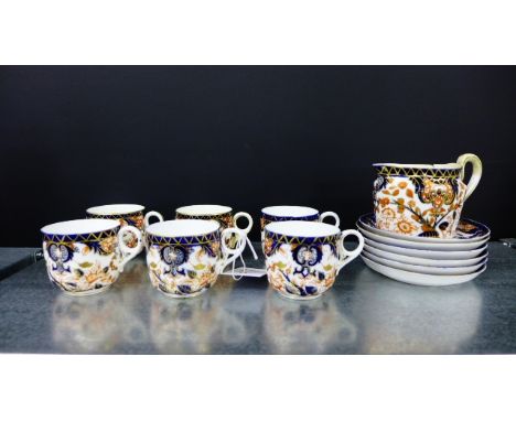 Derby Imari pattern tea wares to include six cups, six saucers, and a cream jug (some damages)