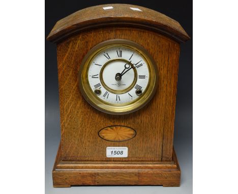 An early 20th century oak and marquetry mantel clock, white enamel chapter ring, twin winding holes 