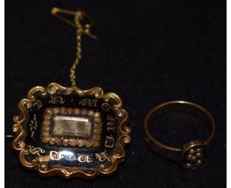 A Victorian mourning brooch, central rectangular  hair work lattice, seed pearl, frame within a black enameled scrolling band