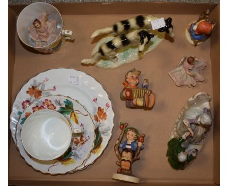 A pair of Dresden dancers, lace skirts; a West German figure of a pair of dogs; hand painted cups and plates; three Hummel fi