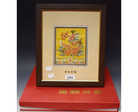 A Chinese Nanjing Yun brocade, embroidered in silk with a dragon chasing a flaming pearl, framed, silk box