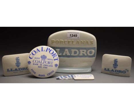A Lladro porcelain collector's or trader's shop sign; two others smaller; Coalport stand; Goebel tag (5) 