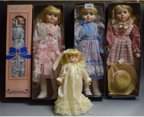 Collector's dolls - four boxed ceramic head dolls in a variety of costumes; one other