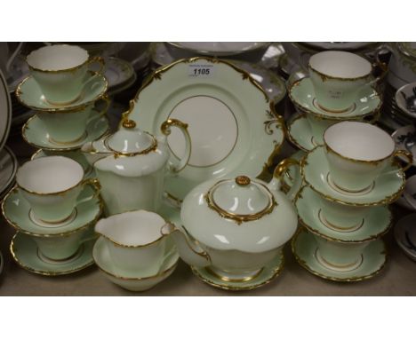 A Paragon tea service for twelve (missing one cup), pale green with gilded edging pattern 3849, comprising cups and saucers, 