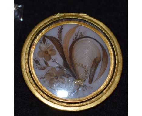 A George III hair work and seed pearl locket converted brooch, painted opaline milk glass panel inset and adorned with hair w