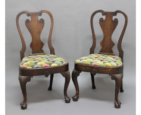 PAIR OF GEORGE I WALNUT DINING CHAIRS, the vase shaped splat with flowerhead carving above a tapestry upholstered seat, cabri