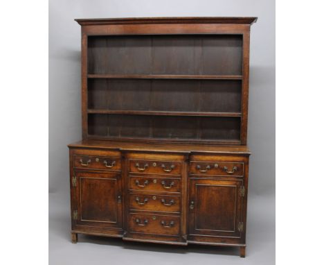 WELSH OAK BREAKFRONT DRESSER, 19th century, the three shelf plate rack on a base with an arrangement of six drawers and two c