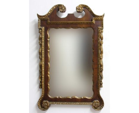GEORGE III STYLE WALL MIRROR, the shaped rectangular plate in a mahogany and parcel gilt frame, height 98cm, width 61cm