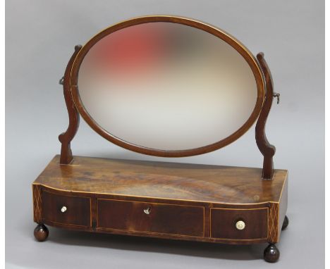 GEORGE III MAHOGANY AND INLAID TOILET MIRROR, the oval mirror on a shaped rectangular base with three drawers, height 52cm, w
