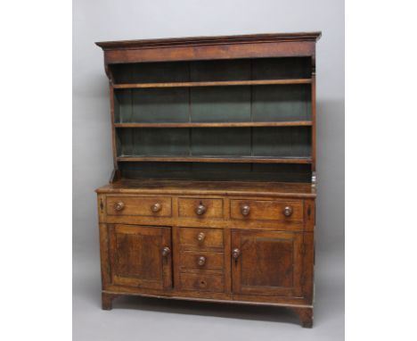 GEORGE III OAK DRESSER, possibly North Wales, the three shelf plate rack on a base with a T arrangement of drawers and a pair