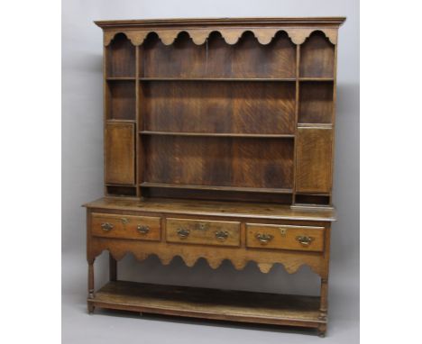 OAK DRESSER, 18th century, the plate rack with three shelves, two cupboards and two small drawers on a base with three drawer
