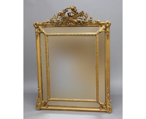 FRENCH GILT GESSO CUSHION MIRROR, 19th century, the bevelled glass plates below a gilt torch and quiver among foliate and rib