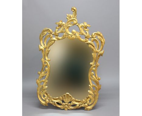 FRENCH GILTWOOD WALL MIRROR, the shaped plate in a pierced, scrolling frame, height 128cm, width 79cm