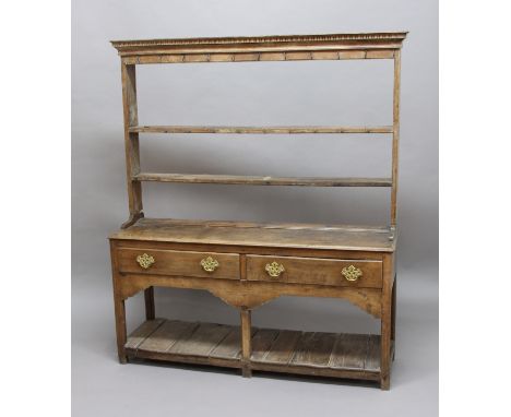 OAK DRESSER, late 17th/early 18th century, the two shelf plate rack on a base with two drawers and open pot shelf, height 170