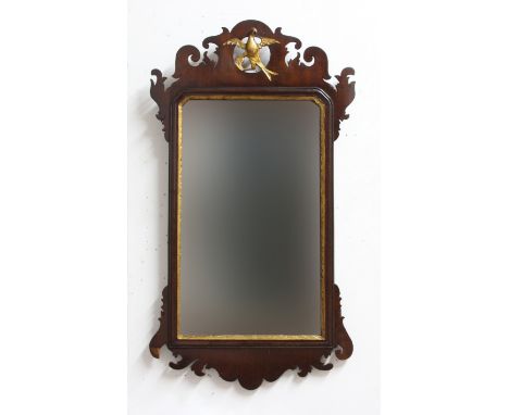 GEORGE III FRET CARVED WALL MIRROR, the rectangular plate with parcel gilt border beneath a gilt ho-ho bird, height 80cm, wid