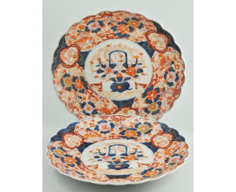 Pair of Japanese Imari chargers, centre decorated with a basket of flowers, lightly lobed, diameter 38cm.