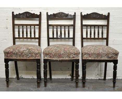 Three Edwardian stained beech chairs, with bobbin rail backs, stuff over seats.