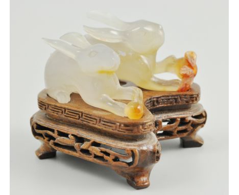 Small jade carving of two rabbits, on a bespoke wooden stand, 5cm.