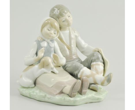 Lladro group of a seated boy and girl with puppy, 16cm.