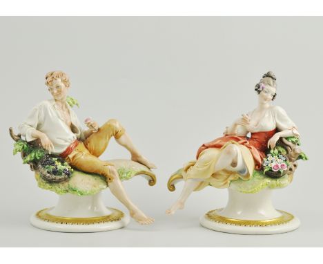 Pair of Italian figures, boy with fruit basket, girl with flower basket.