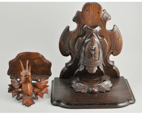 Continental carved oak clock bracket, depicting the face of a King and a smaller similar Black Forest dial bracket.