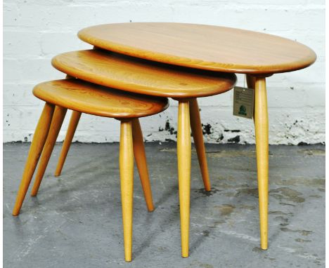 Ercol pale ash nest of three "Pebble" graduated tables, on triform supports.