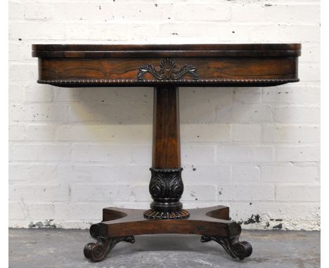 Regency rosewood fold over card table, with baize inset, crossbanded, raised on a circular column, with carved stick leaf bas